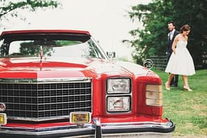 couple and red car